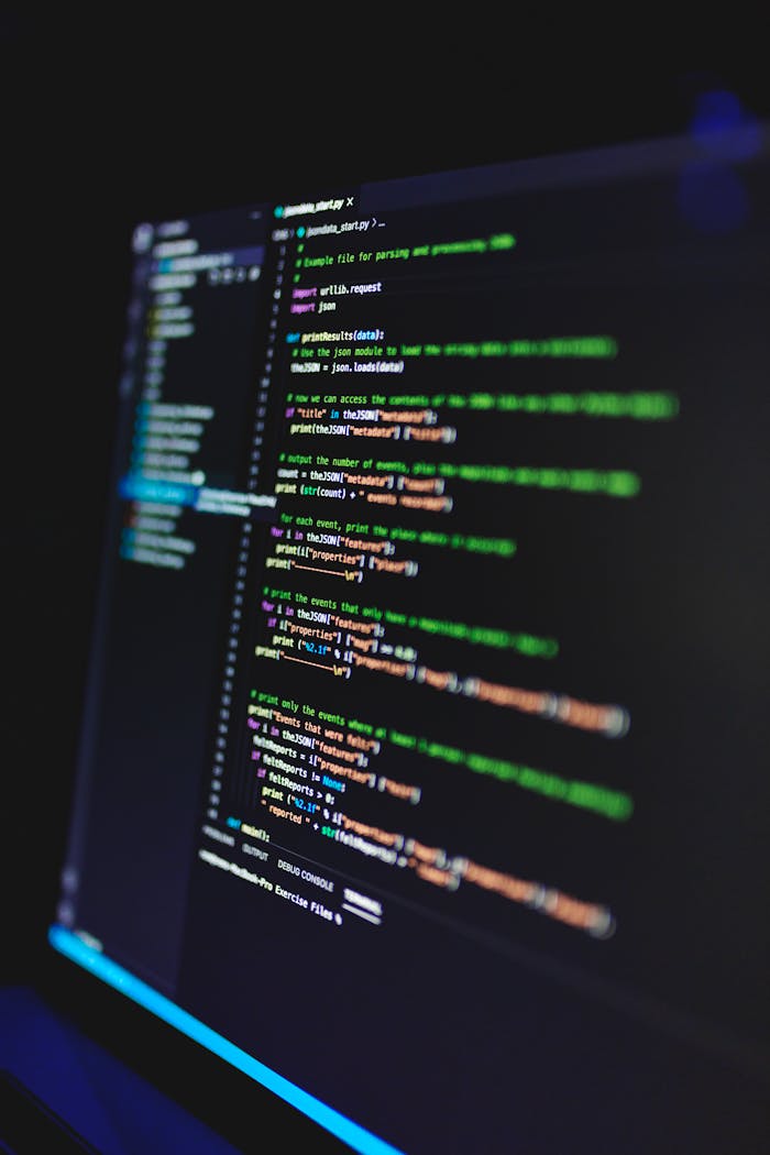 Services Vertical shot of colorful programming code on a screen in a dark room, highlighting technology work.