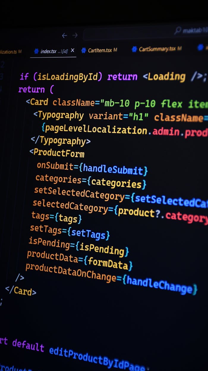Services Close-up of JSX code on a monitor, showcasing colorful syntax used in ReactJS development.